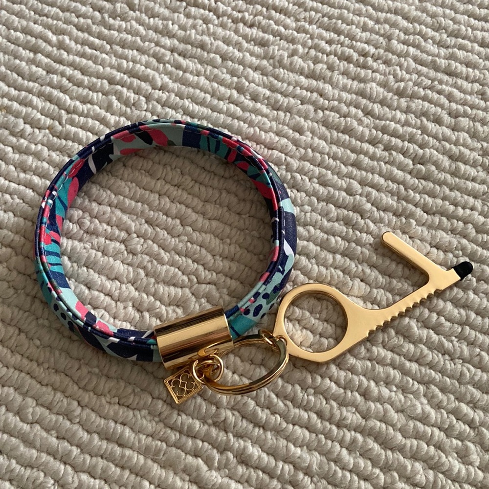 Leather wristlet key ring with touchless door opener.